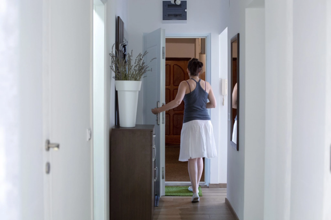 woman opening door