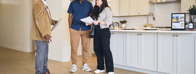 real estate agent showing new home to prospective buyers